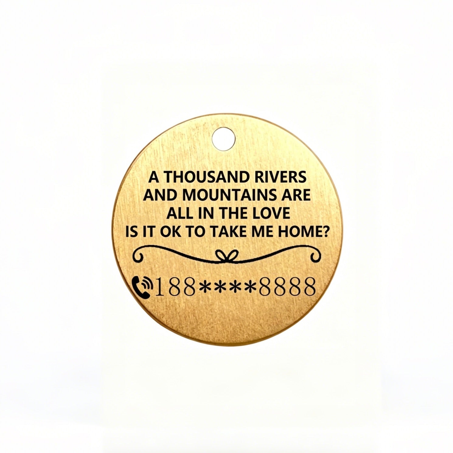 Gold pendant with engraved text on a white background