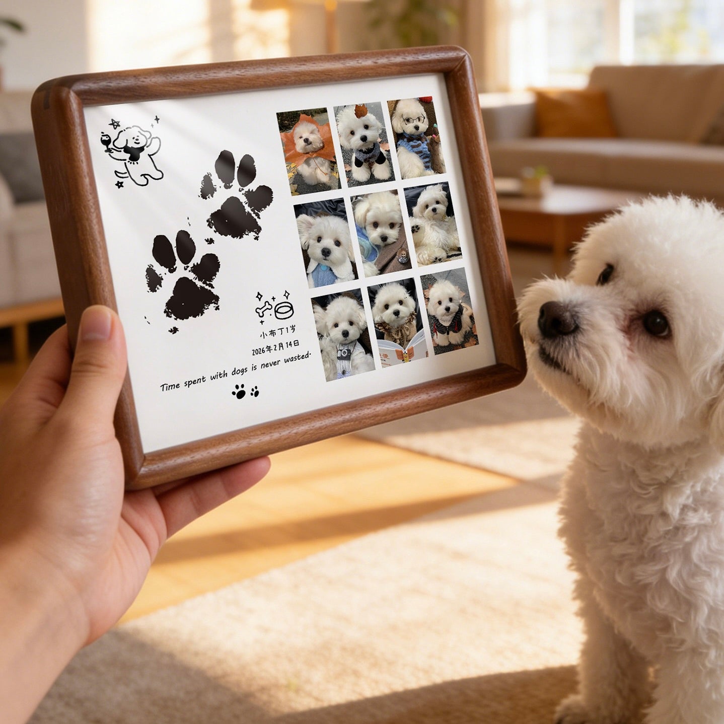 Person holding a framed photo collage of a dog with paw prints in a living room.