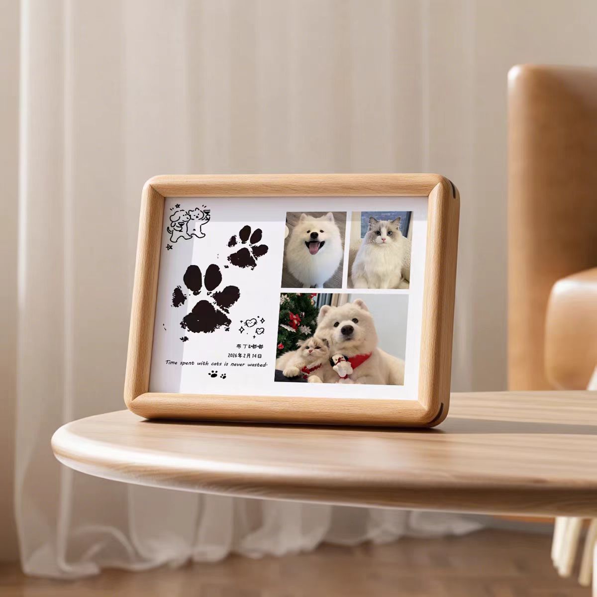 Wooden photo frame with paw print and pet photos on a table