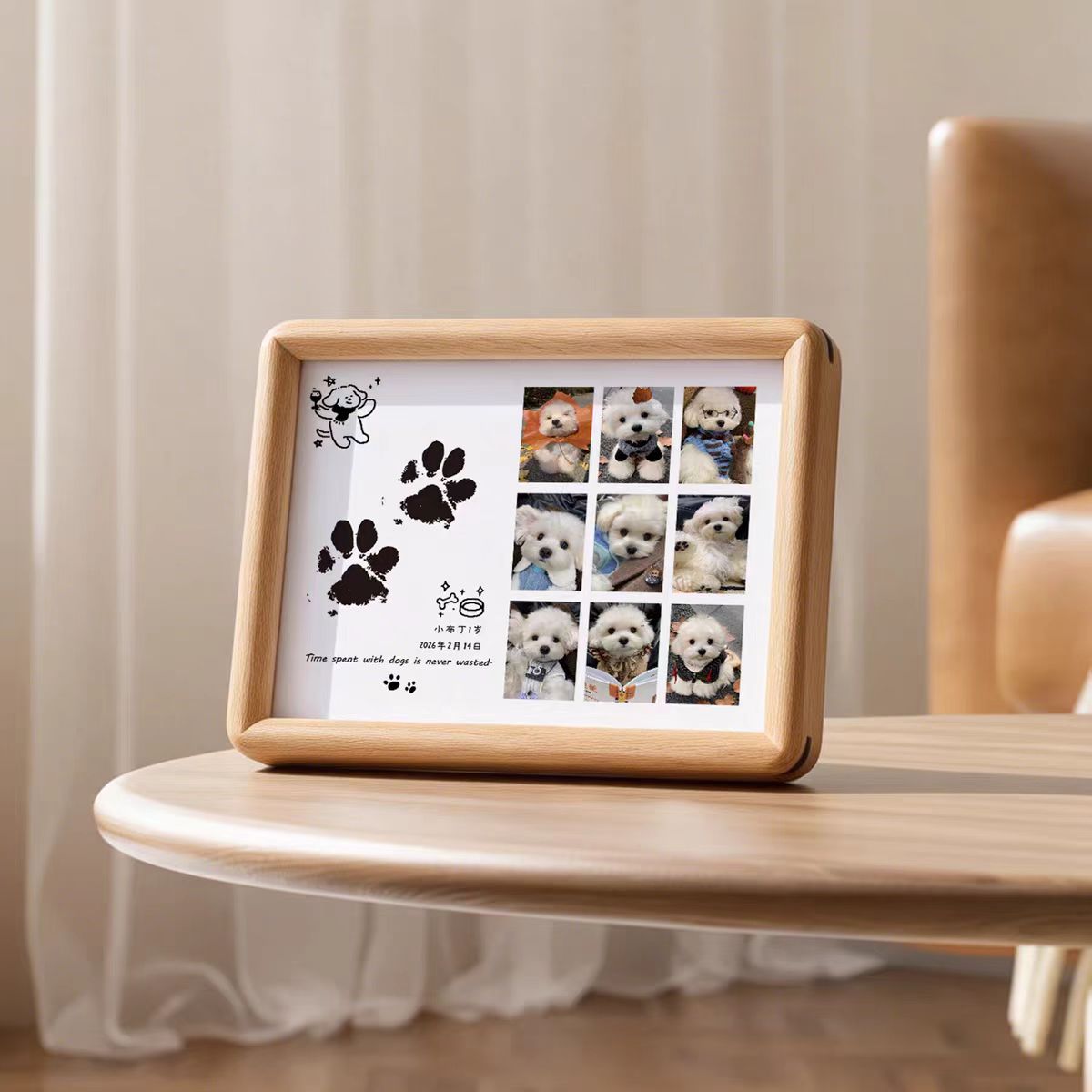 Wooden photo frame with pet photos and paw prints on a table.