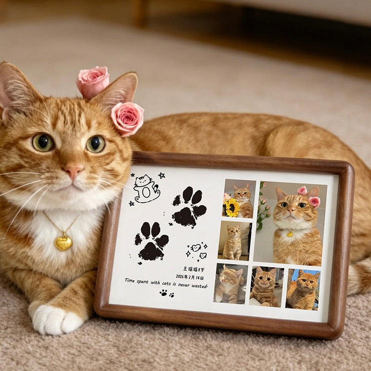 Cat with flower headband next to a framed photo of itself