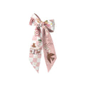 Pink and white patterned bow on a white background