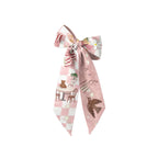 Pink and white patterned bow on a white background