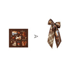 Decorative ribbon with autumn-themed design featuring animals and leaves on a white background.