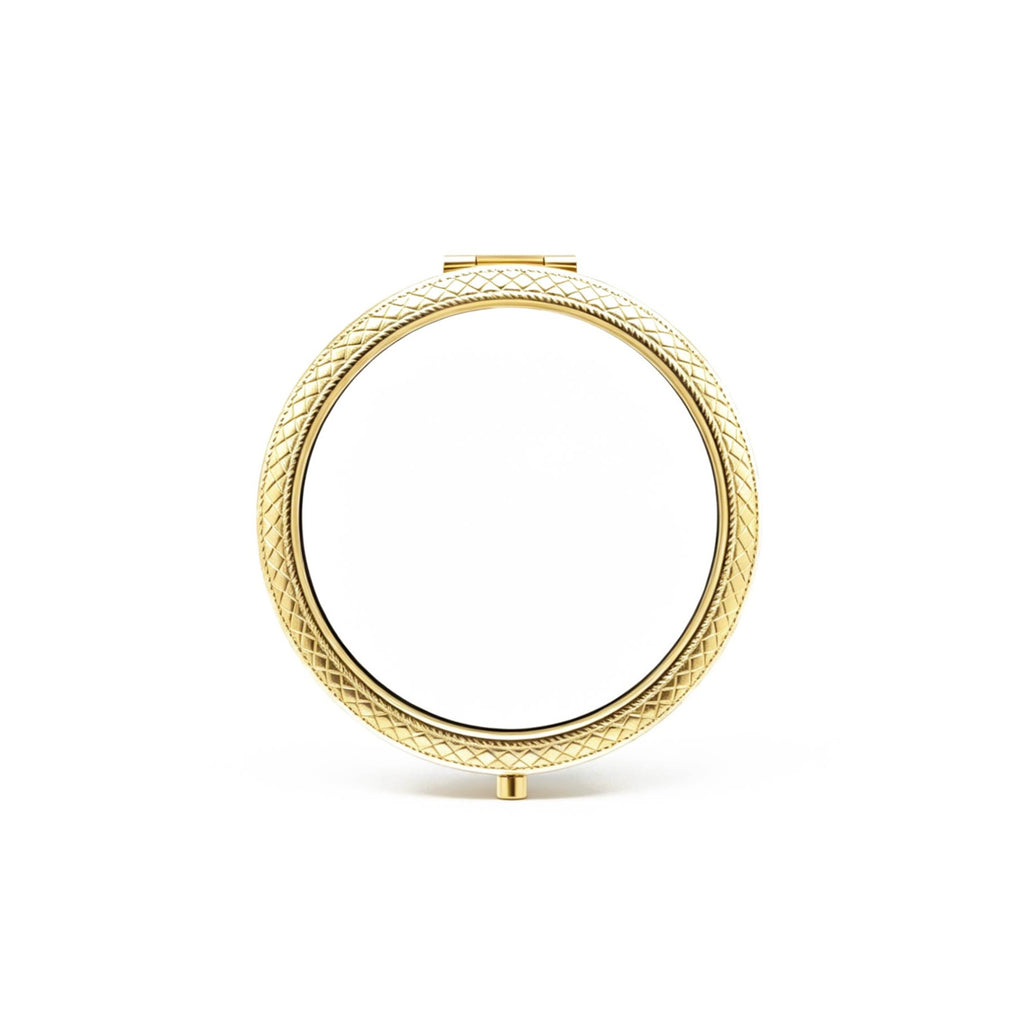 Gold circular mirror with textured frame on a white background