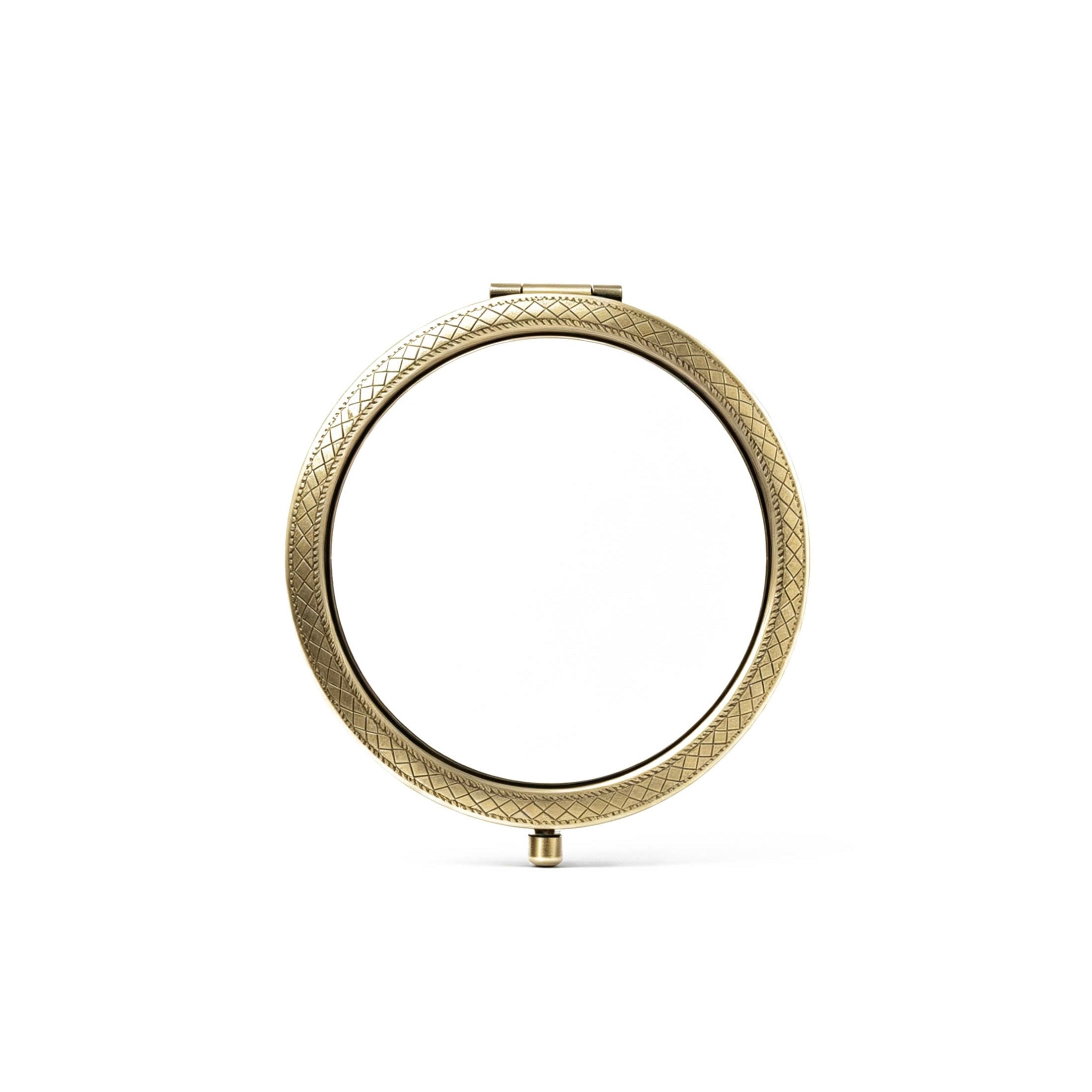 Gold circular compact mirror on a white background