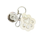 Keychain with paw print design and 'Lucky Baby' charm on a white background