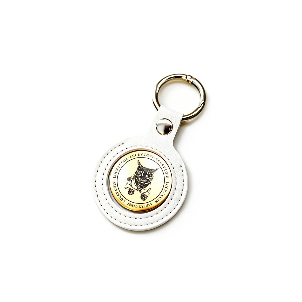 Round keychain with a cat design on a white background
