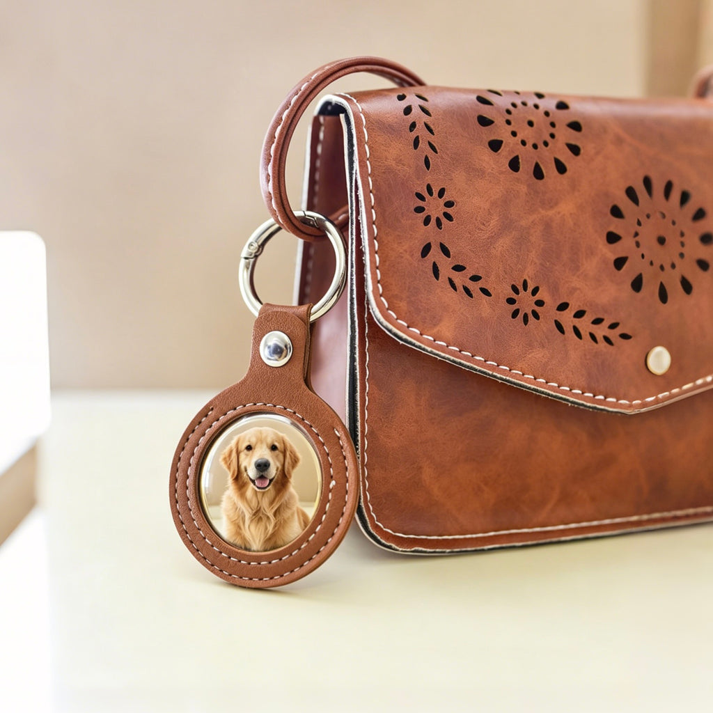 Brown leather bag with a keychain featuring a dog's photo on a light background