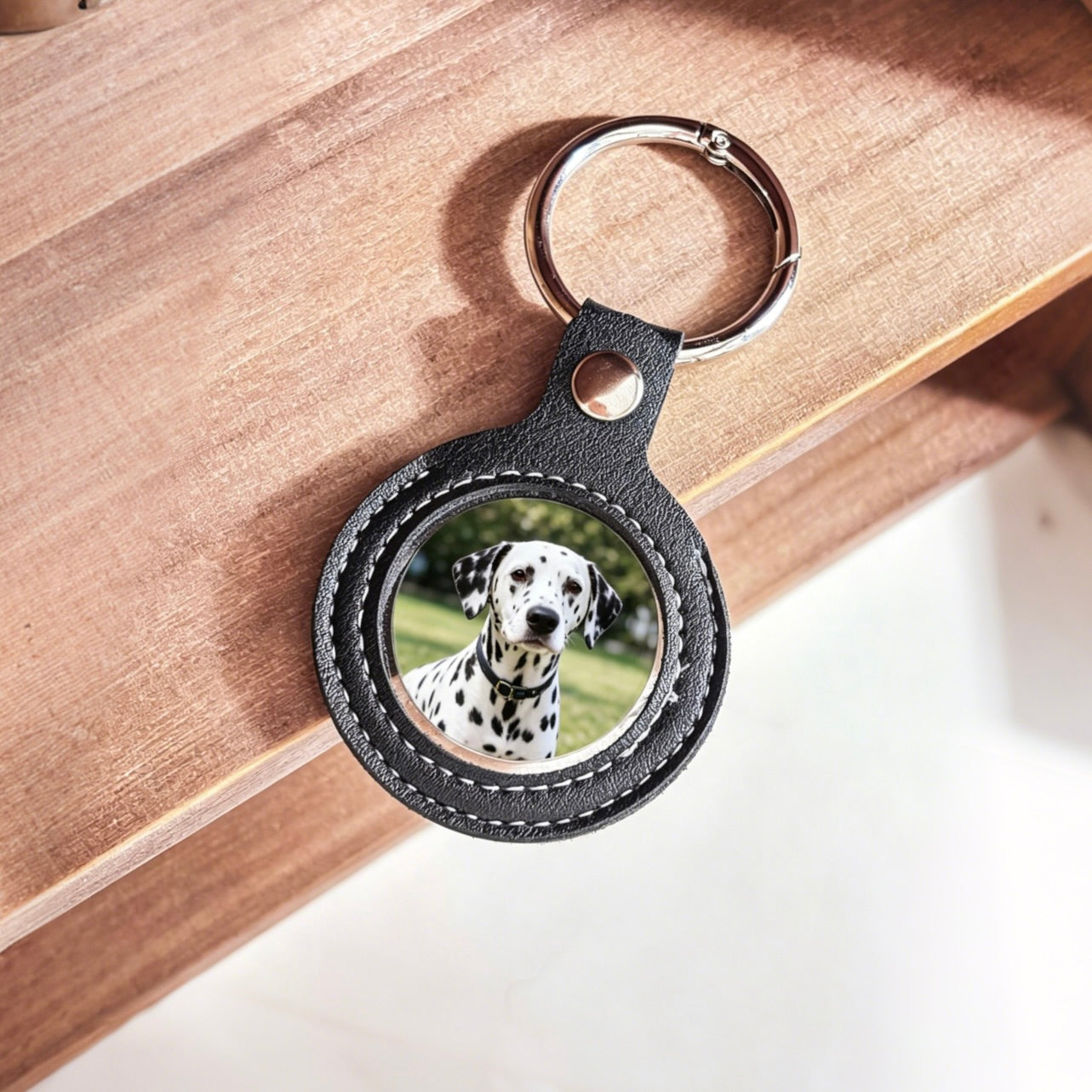 Black leather keychain with a photo of a Dalmatian dog on a wooden surface