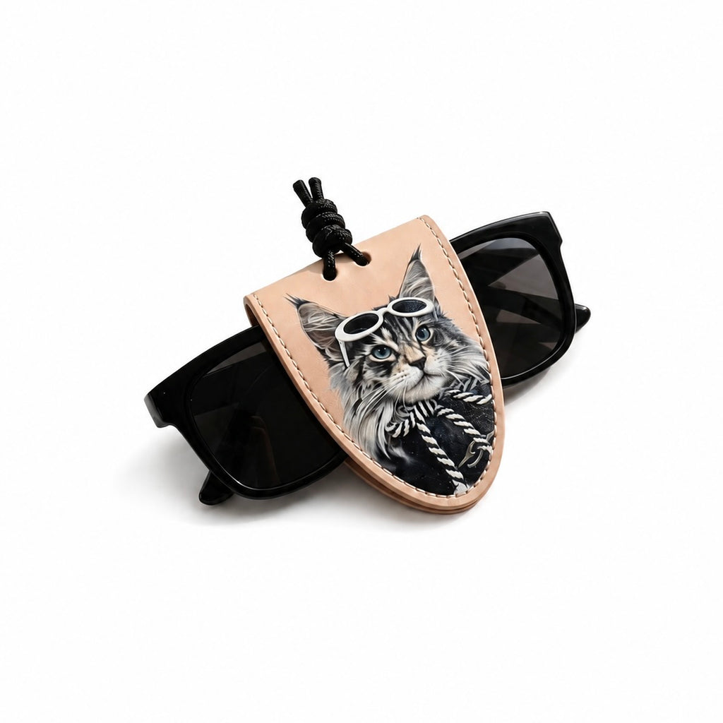 Sunglasses with a tan leather case featuring a cat design on a white background