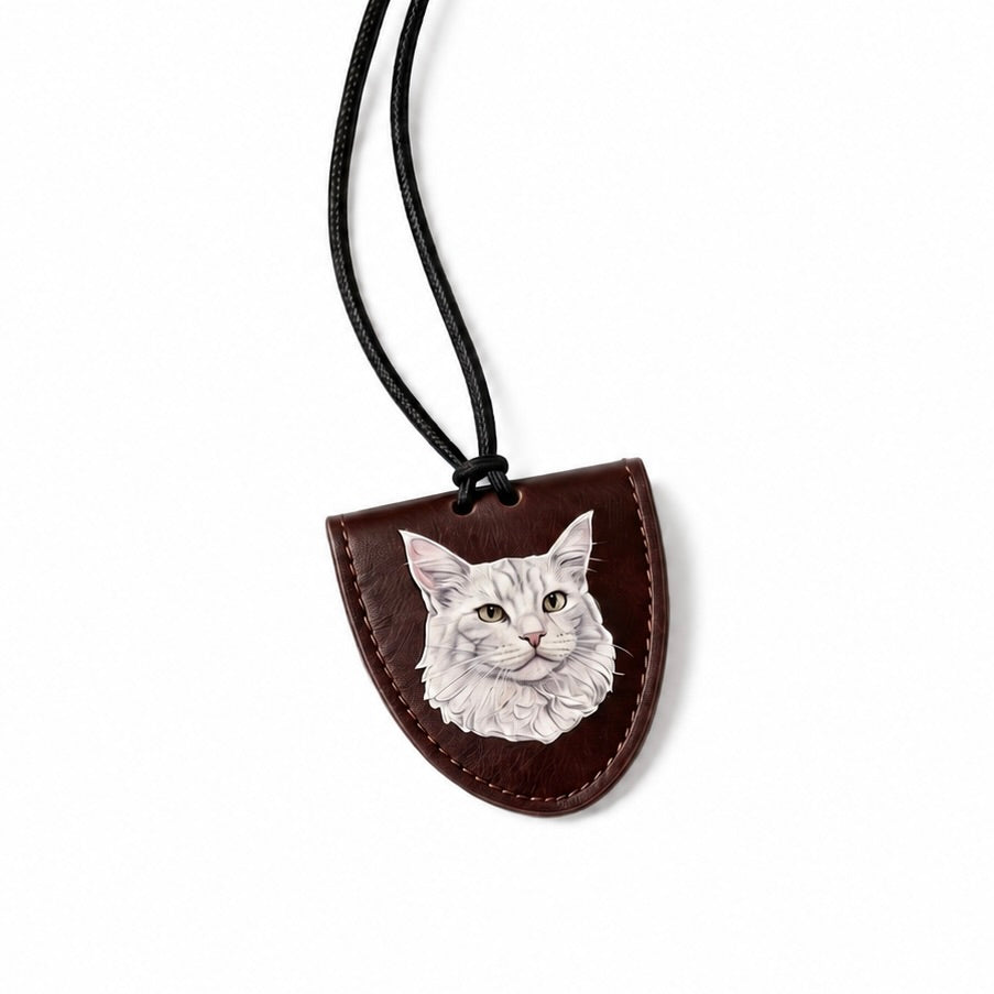 Leather necklace pendant with a cat's face engraving on a white background