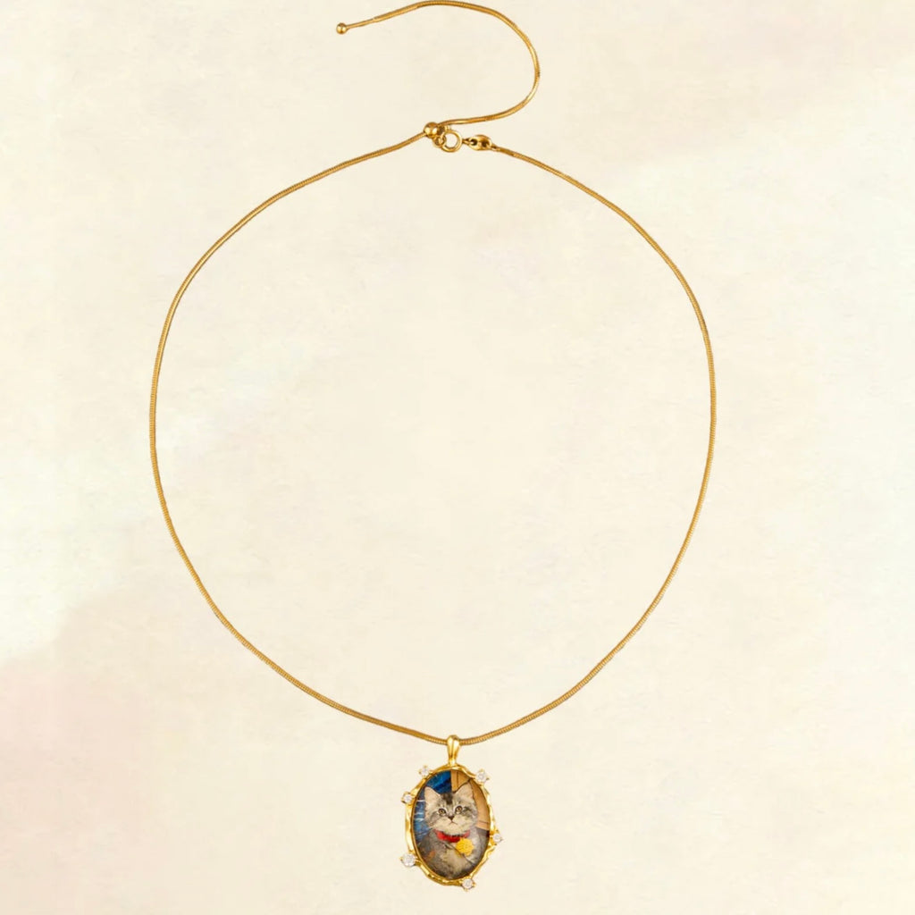 Gold necklace with a pendant on a beige background