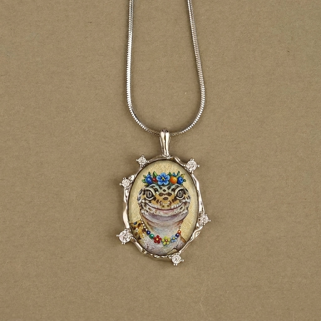Pendant necklace with a cat illustration on a beige background