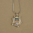 Pendant necklace with a cat illustration on a beige background