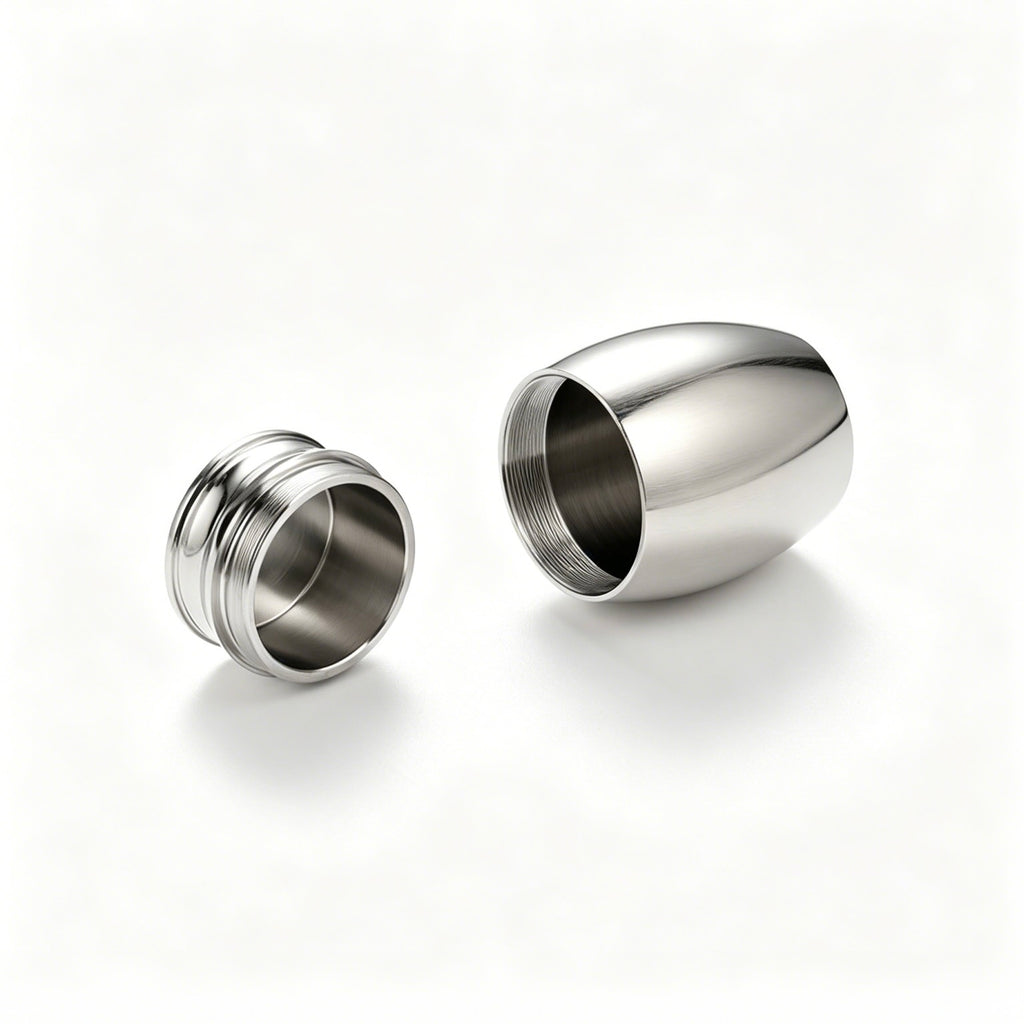 Two metallic earplugs on a white background