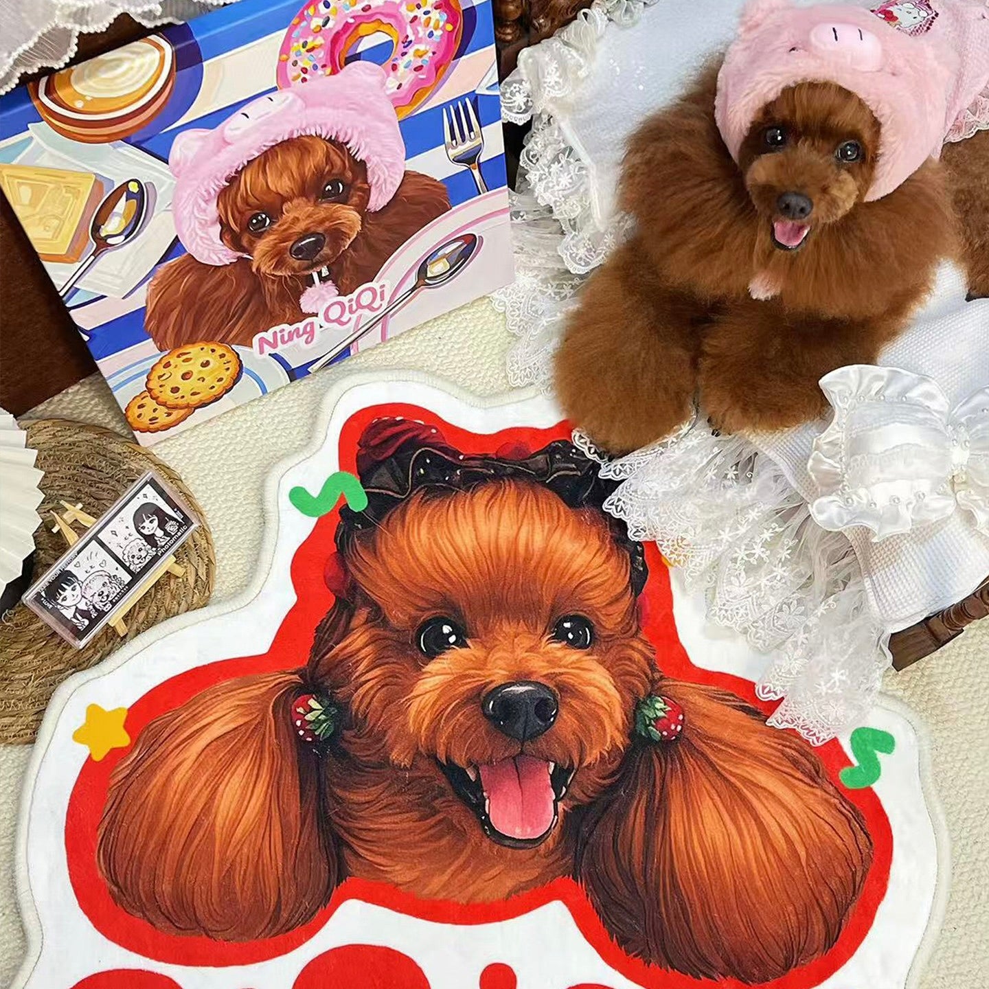 Two small brown dogs wearing pink hats with a cartoon character and food illustration in the background.