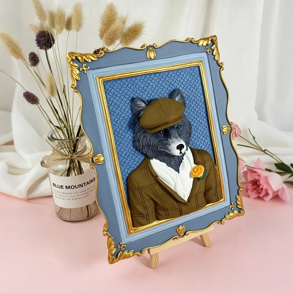Framed artwork of a wolf wearing a suit with a flower, placed on a pink surface with decorative elements.