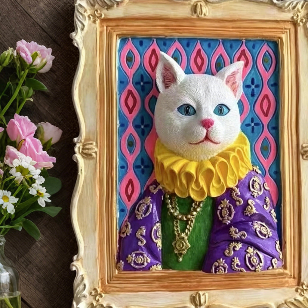 Decorative cat figurine in an ornate frame with a colorful background, next to flowers.