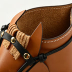 Close-up of the interior of the leather horse desk organizer designed for pens and makeup brushes.