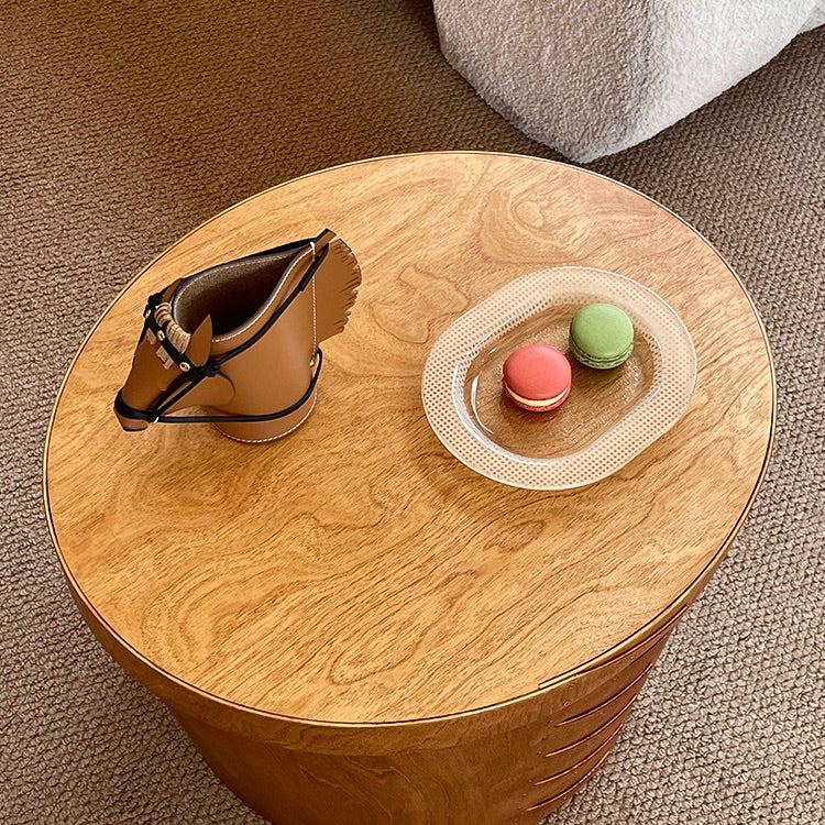 Luxury equestrian-inspired leather horse pen holder displayed on a wooden side table next to a plate of macarons.