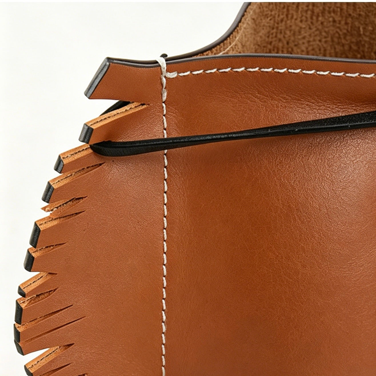 Close-up of the interior of the leather horse desk organizer designed for pens and makeup brushes.