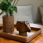 Hand-stitched brown leather horse desk organizer with decorative tassels and sculptural horse head silhouette.