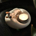 Matte white plaster sleeping French Bulldog candle holder and jewelry trinket tray with a lit tealight candle