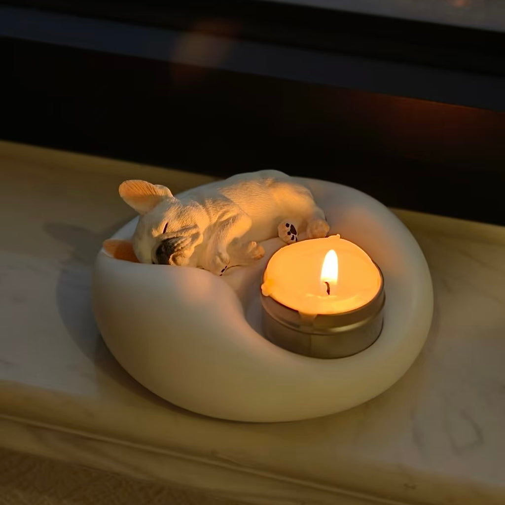 Matte white plaster sleeping French Bulldog candle holder and jewelry trinket tray with a lit tealight candle
