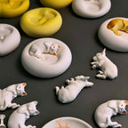 Collection of plaster pet candle holders and jewelry trays featuring sleeping French Bulldog and cat designs