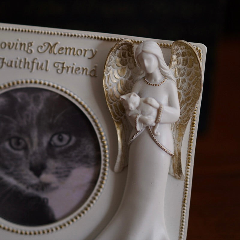 Memorial plaque with angel holding a cat and text 'In Loving Memory Faithful Friend' on a dark background.