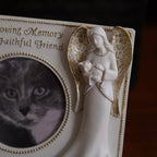 Memorial plaque with angel holding a cat and text 'In Loving Memory Faithful Friend' on a dark background.