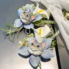 Hand-painted plaster silver tabby cat wedding boutonniere lapel pin with light blue artificial orchid flowers and pearls.