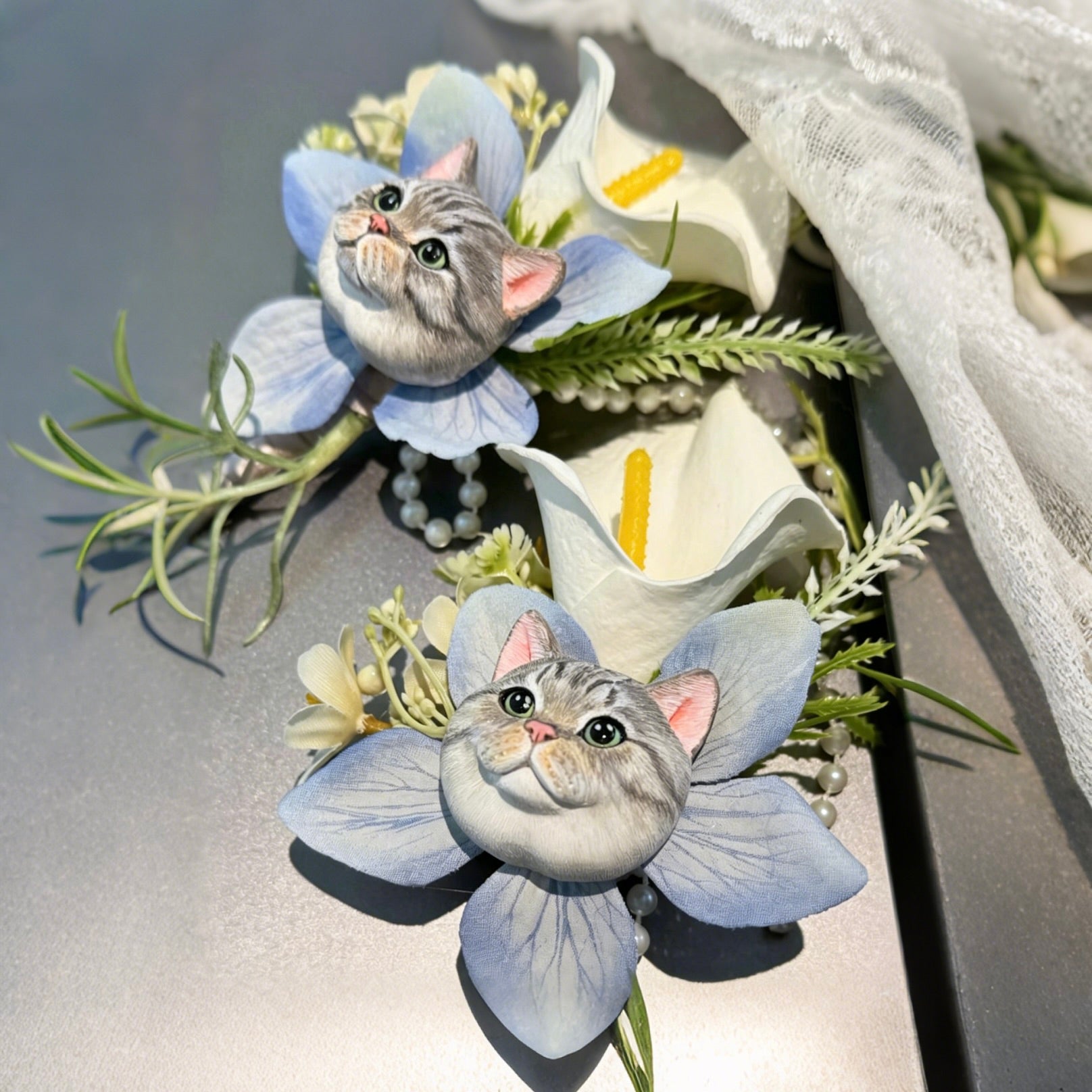 Hand-painted plaster silver tabby cat wedding boutonniere lapel pin with light blue artificial orchid flowers and pearls.