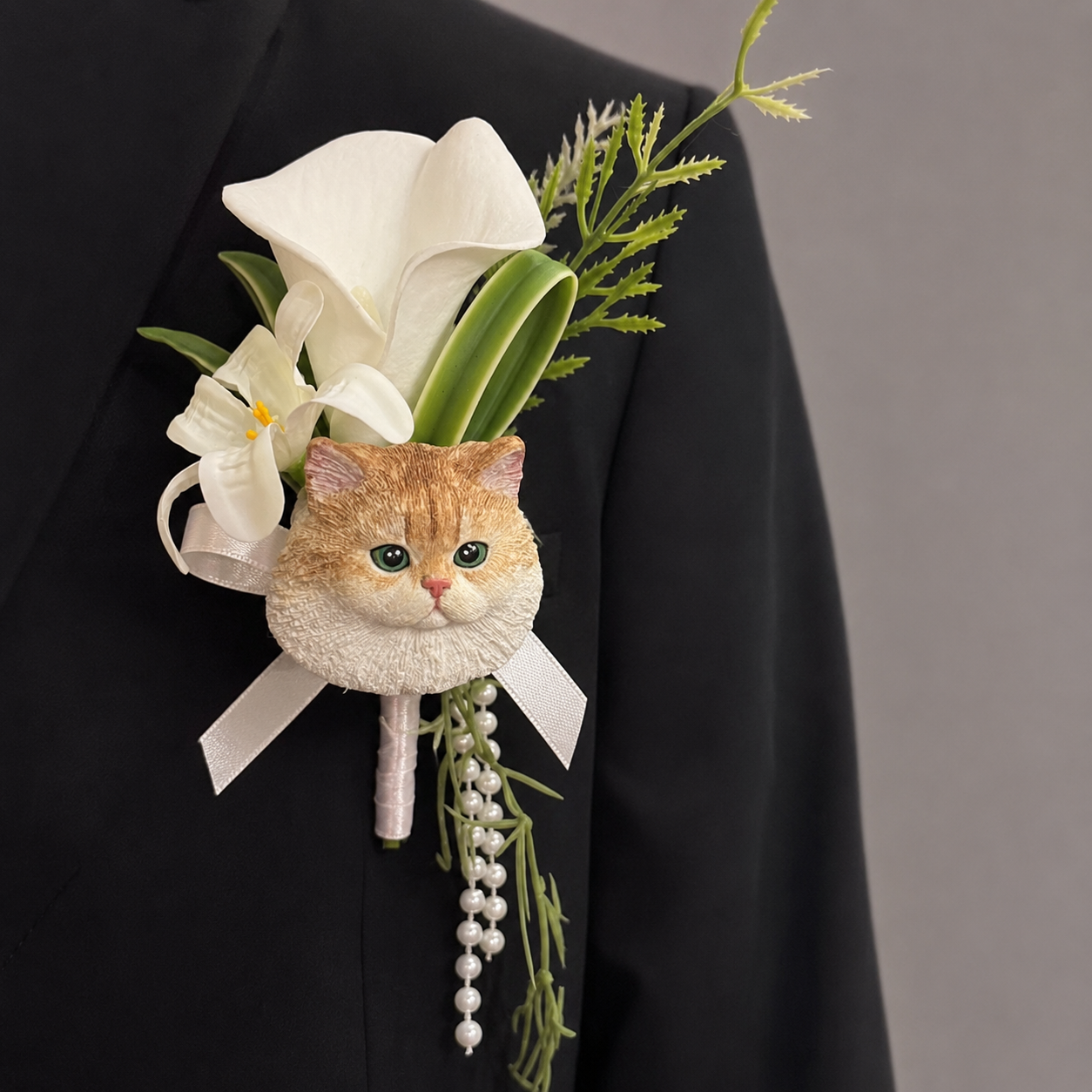 Hand-painted plaster Ragdoll cat wedding boutonniere lapel pin with lotus pink artificial petals and hanging pearls.