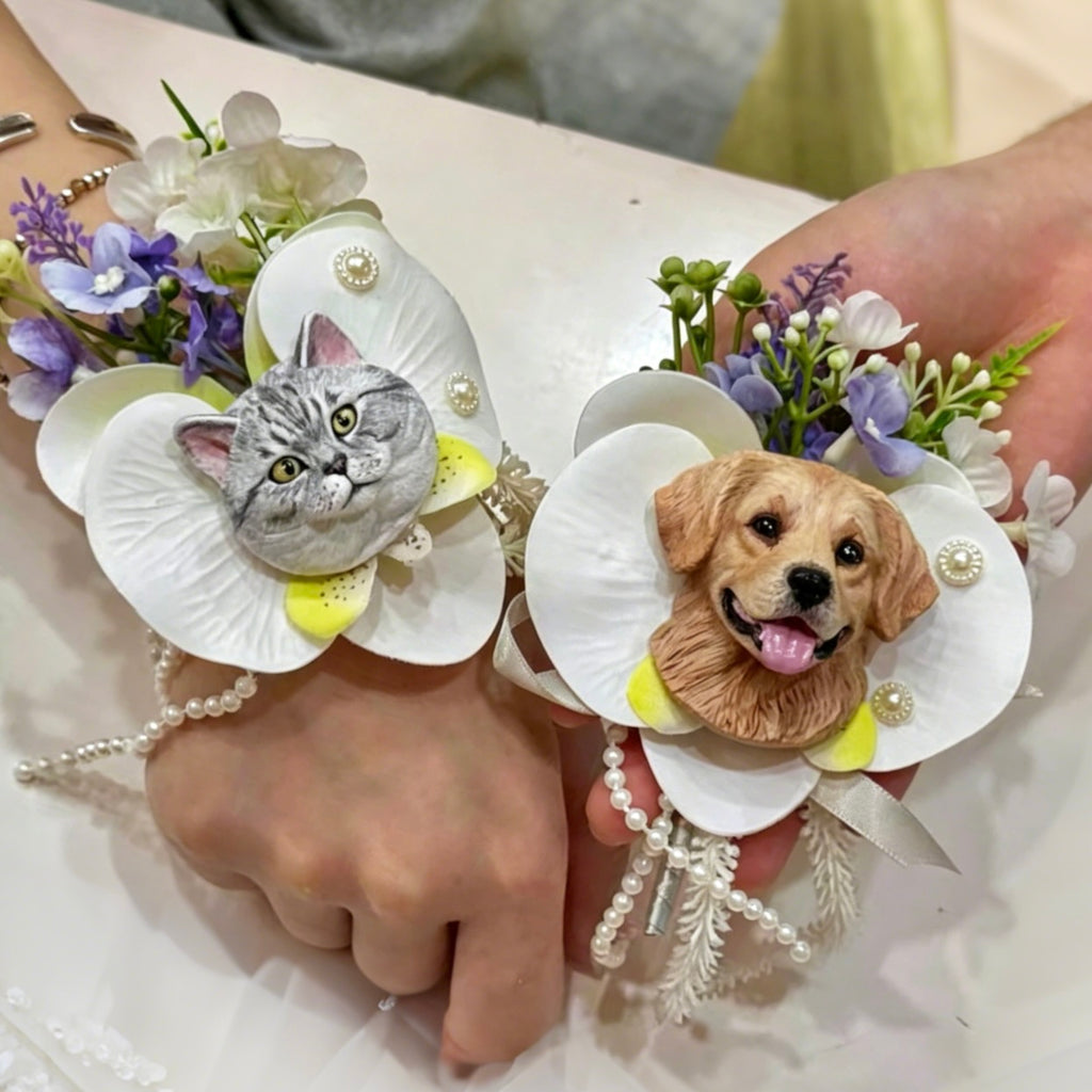 Hand-painted plaster grey tabby cat and Golden Retriever dog wedding boutonnieres with white orchids and pearls.