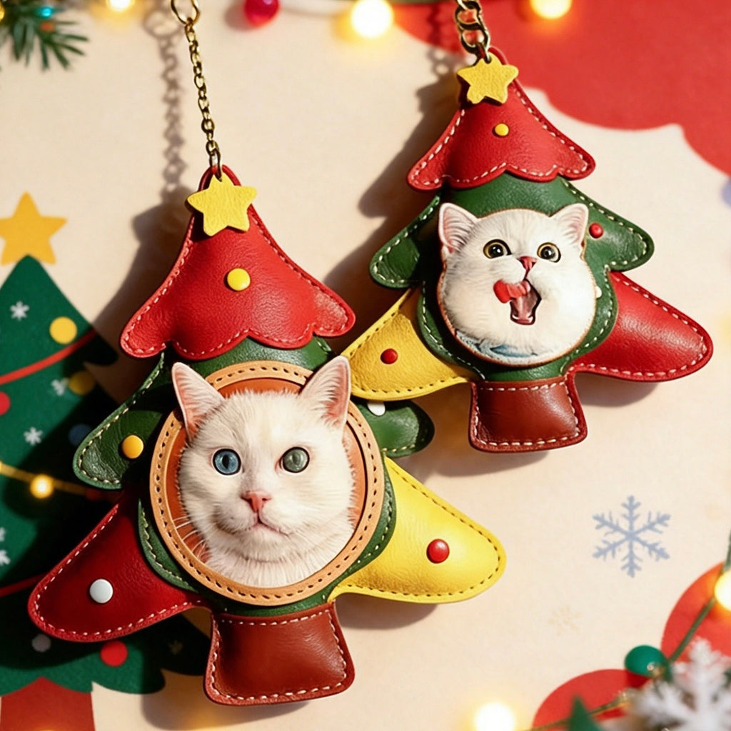 Two cat-themed Christmas tree ornaments with a white cat face design on a festive background.
