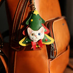 Cat-shaped Christmas tree keychain on a brown leather bag