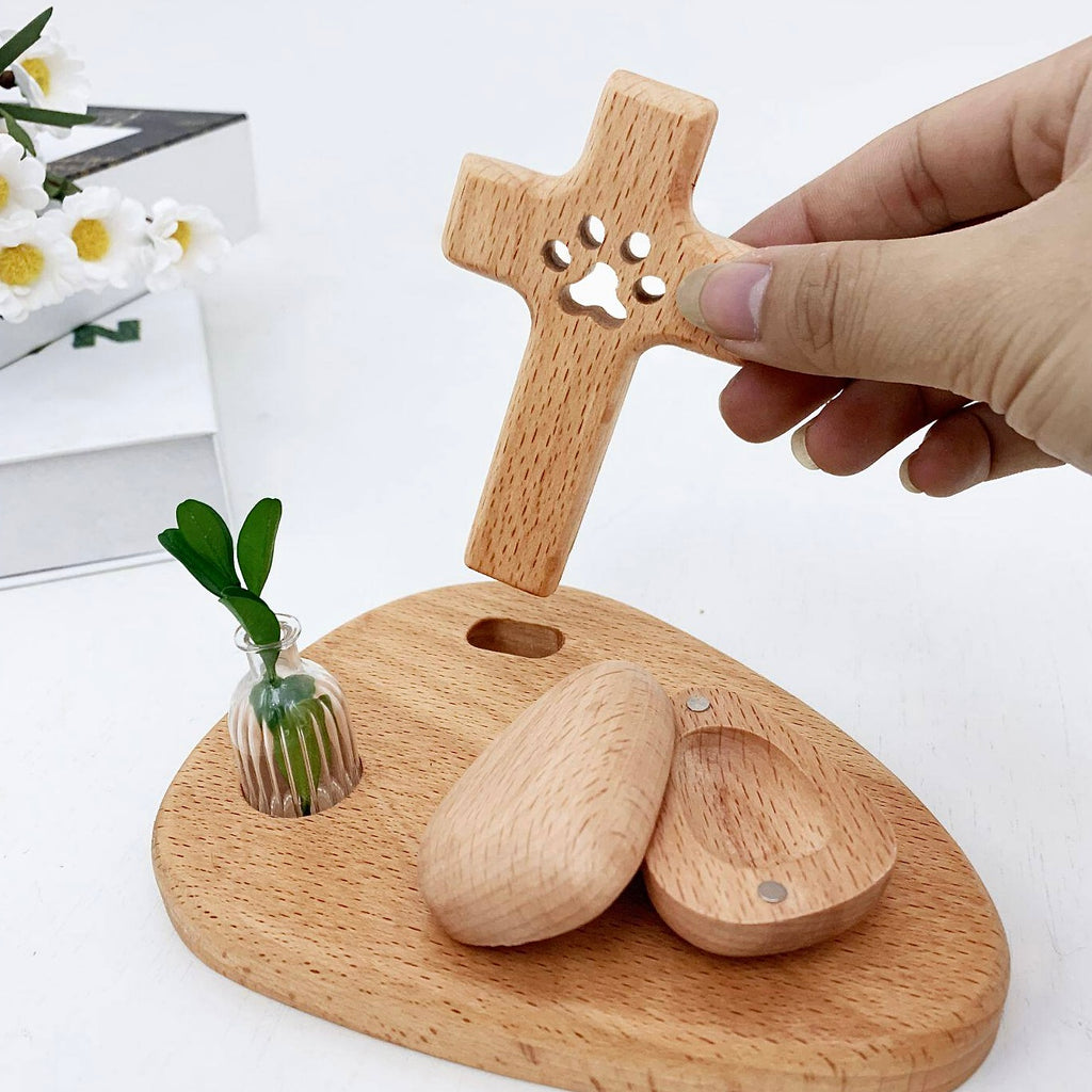 Wooden pet memorial with paw print design on a white background