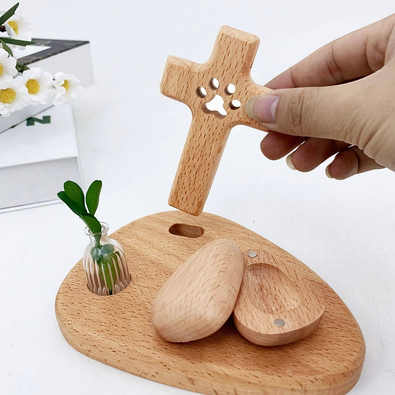 Wooden pet memorial with paw print design on a white background