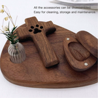 Wooden pet accessory set on a wooden tray with a small vase of flowers.