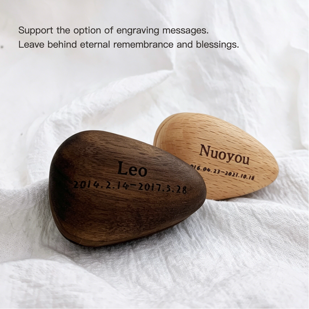 Two engraved wooden stones on a white fabric background with text about engraving messages.