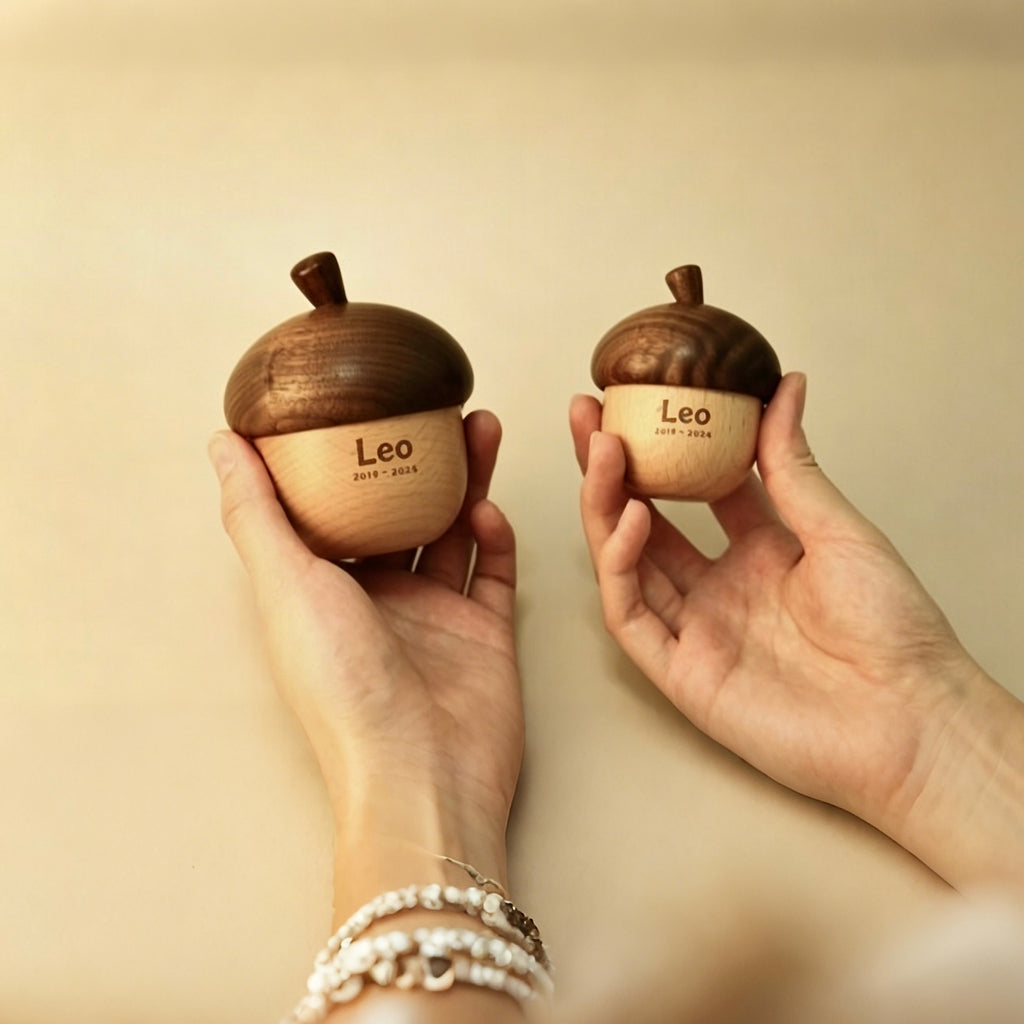 Two hands holding wooden acorn-shaped objects with 'Leo' engraved on a beige background