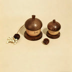Two wooden acorn-shaped containers labeled 'Leo' and 'Lucky' on a beige background.