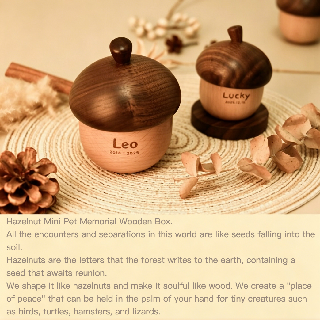 Wooden pet memorial box shaped like an acorn with 'Leo' and 'Lucky' inscriptions, surrounded by dried flowers and pinecones.