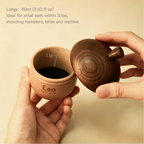 Wooden container with a lid held by hands on a beige background