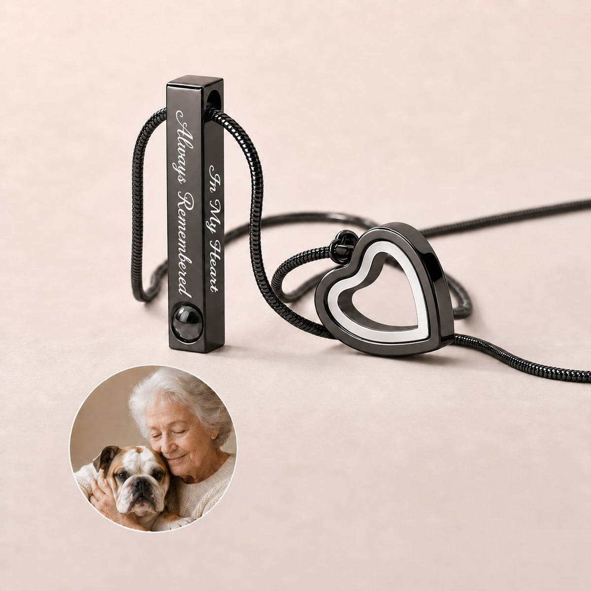 An older woman gently holding a black projection urn necklace, featuring a rectangular bar engraved with "Always Remembered" and an openable heart keepsake compartment.