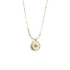 Gold necklace with a pendant on a white background