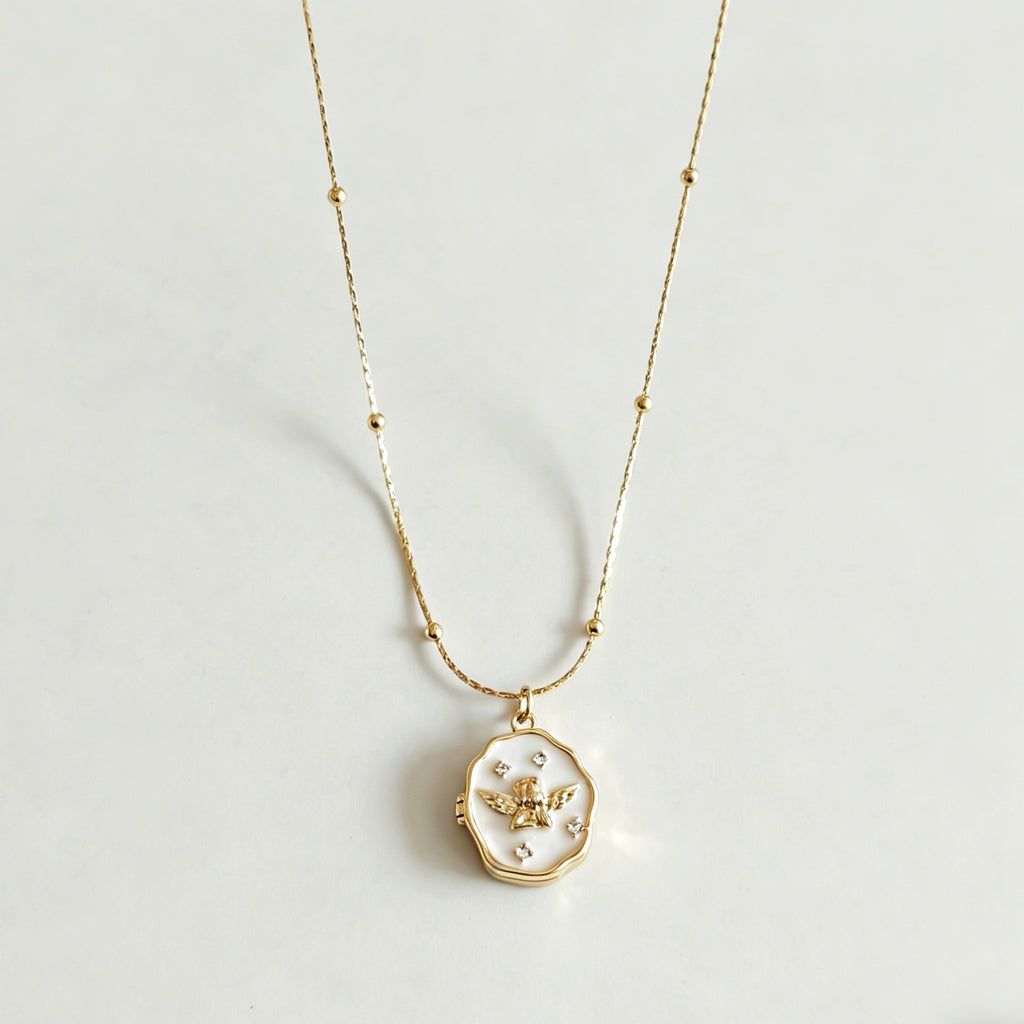 Gold necklace with a pendant on a light gray background