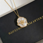 Gold necklace with a pendant on a black box labeled 'Everyday Jewellery'.